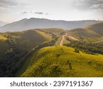 aerial view on the peak in sunset the village far from civilization Traveling on a difficult road. Beautiful sunset view on the hilltop complex. The sun shone through mountain peak after mountain.