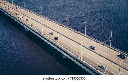 Aerial View On Traffic Bridge Over River In Sunny Autumn Day, Cars On Bridge