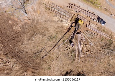 Aerial View On Tree Removal Crane Operator Loading Logs To Truck For New Construction Plase