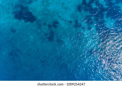 Aerial view on turquoise waves, water surface texture.