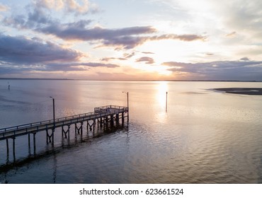 Aerial view on the wooden quay on Pacific Ocean. Picture taken in White Rock, Greater Vancouver, BC, Canada, during a cloudy sunset.