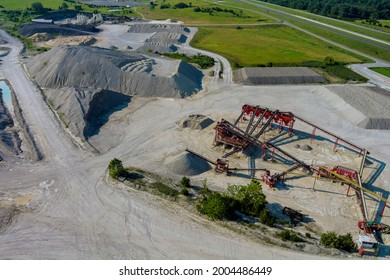 Aerial view of open cast mining panorama quarry with lots at work of machinery equipment at a quarries
