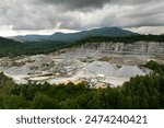 Aerial view of open pit mining site of limestone materials extraction for construction industry