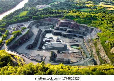 Aerial View Of Opencast Mining Quarry In The Middle Of The Forest 