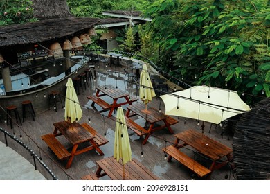 aerial view of outdoor cafe with wooden table and chairs after rain - Powered by Shutterstock