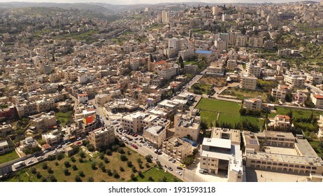 Aerial view over Bethlehem City, Palestinian Authority
Drone view over buildings and green fields, at morning 
 - Shutterstock ID 1931593118