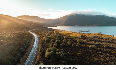 Aerial View over blue lake and green mountain at sunrise. Road to mountain along Lake Rotoaira ,North island ,New Zealand - Powered by Shutterstock