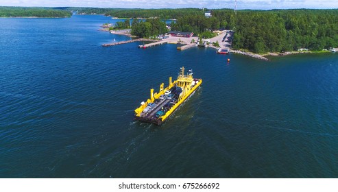 Aerial view over a cable ferry floating between korppo and Nagu parnas ferry terminal, on a sunny summer day, in the finnish archipelago of Turku