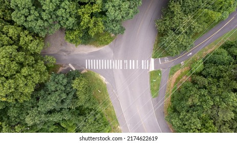 An Aerial View Over A Large Tower And Electrical Power Lines In The Midst Of Tall Green Trees On A Sunny Morning On Long Island, NY.