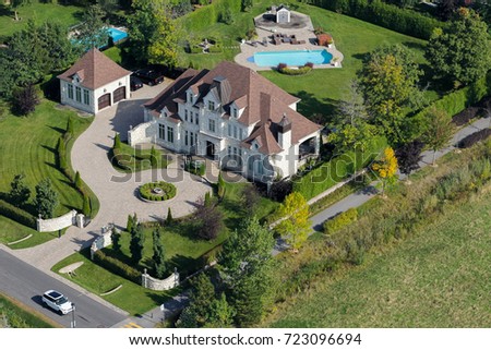 Aerial view over a large upscale luxury house on a sunny summer day. Canada.