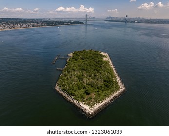 An aerial view over Lower Bay by Staten Island, New York on a beautiful day. The drone camera shows the calm waters near Hoffman Island.