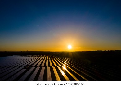 Aerial View Over A Modern Solar Farm At Sunrise