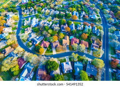 Aerial View Over Modern Suburb Home Community neighborhood with colorful Fall Autumn trees around curved streets and new development outside of Austin , Texas 