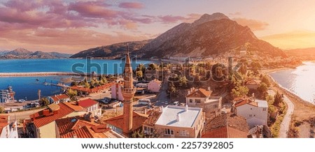 Aerial view over rooftops and mosque minaret in Egirdir, Isparta province in Turkey. Travel sightseeing and religious tourism.