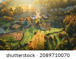 Aerial view over scenic playground among autumnal trees at sunrise. Telford Centre Park in United Kingdom