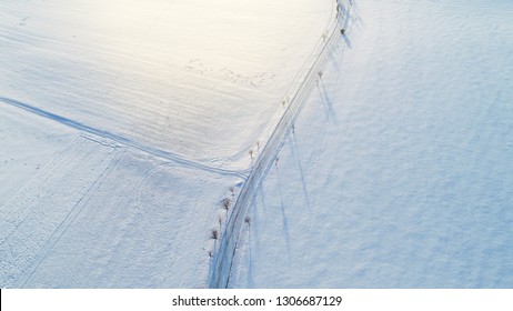 Aerial view over the the snowy field and road. Minimalist landscape concept. - Powered by Shutterstock