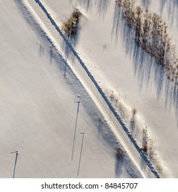 Aerial View Over Snowy Field And Road