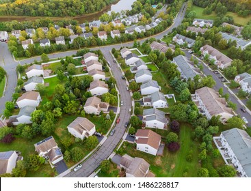 Aerial view over suburban homes and roads aerial view of residential early sunrise - Powered by Shutterstock