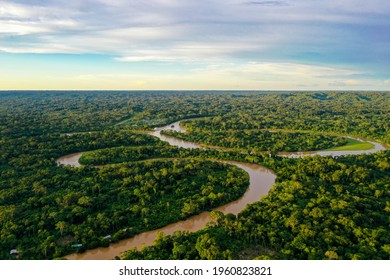 Aerial view over a tropical forest with a river in the amazon rainforest - Shutterstock ID 1960823821