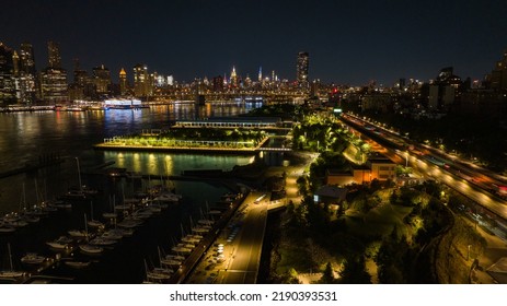 An Aerial View Over Well Landscaped And Lit Park In Brooklyn Heights, NY By The BQE. It Was Taken At Night With A Drone Camera.