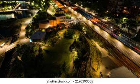 An Aerial View Over Well Landscaped And Lit Park In Brooklyn Heights, NY By The BQE. It Was Taken At Night With A Drone Camera.