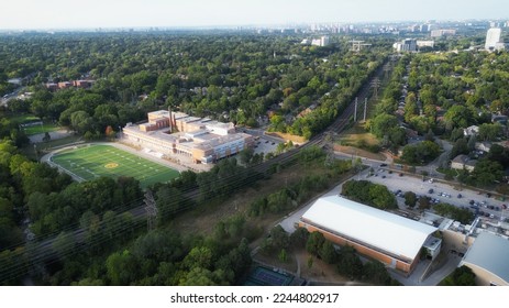 Aerial view over west Toronto, Ontario, Canada looking north-east over a football field and the train tracks that the Toronto transit subway travels between Islington and Royal York stations. - Shutterstock ID 2244802917