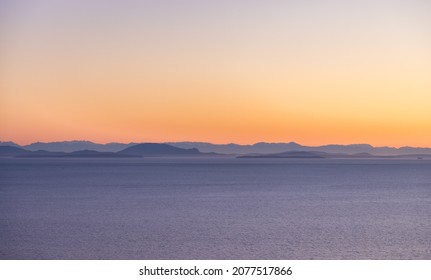 Aerial View Of Pacific Ocean West Coast. Vancouver Island Landscape In Background. Sunny Sunset Sky. British Columbia, Canada. Nature Background