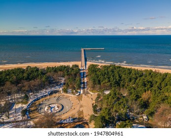 Aerial view of Palanga pedestrians bridge to the sea and coastline with sandy beach in winter
