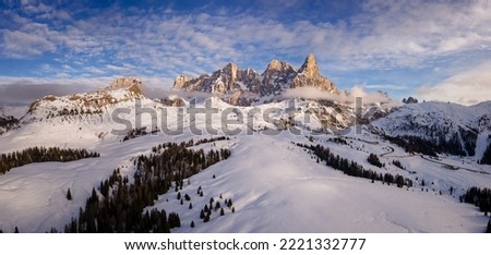 aerial view of Pale di San Martino and Passo Rolle covered with snow in winter, Trento,  Italy