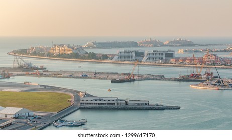 Aerial view of Palm Jumeirah Island timelapse. Evening top view with villas, hotels and yachts. Construction process of new cruise terminal