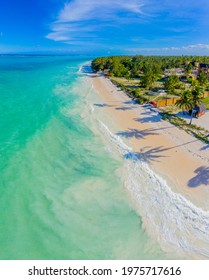 Aerial View Of Palms On The Sandy Beach Of Indian Ocean At Sunny Day. Summer Holiday In Zanzibar, Africa. Tropical Landscape With Palm Trees, White Sand, Blue Water, Hotels. Top View Of Sea Coast