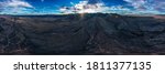 Aerial view and panorama of Arizona mountain ranges during sunset with clouds and sun