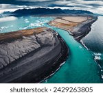 Aerial view panorama of dramatic moody Jokulsarlon glacier lagoon with iceberg floating and black sand beach in Diamond Beach, Iceland