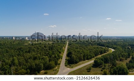 Aerial view panorama of forest and roads near Chernobyl nuclear power plant. Drone shot Exclusion Zone in summer. Radiation, sarcophagus