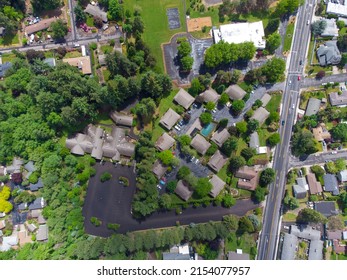 Aerial View. Panoramic Shot Of A Small Town, Suburb. Lots Of Greenery, Small Houses, Paved Roads. There Are No People In The Photo. Maps, Topography, Construction, Housing Issue.