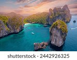 Aerial view paradise Nui beach, turquoise lagoon with white coral sand and palms on sunset time. Landscape koh Phi Phi Don island, Krabi, Thailand.