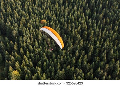 Aerial View Of Paramotor Flying Over The Forest In Poland