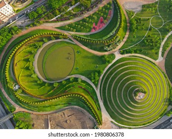Aerial view of Parco del Portello in Milan, near CityLife, Lombardia. View from the height of park with a green lawn and paths. Abstract design similar to a dragon. Drone photography in Milano. - Shutterstock ID 1980806378