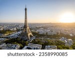 Aerial view of Paris, France, overlooking the famous Eiffel Tower, sunrise in the background.