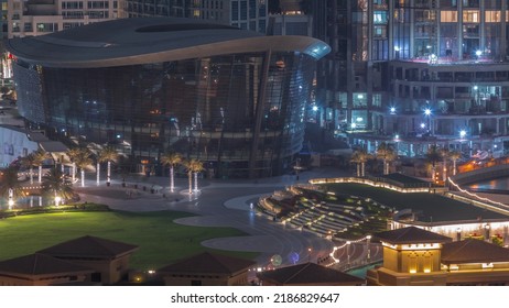 Aerial View Of Park With Green Lawn In Dubai City Timelapse In Downtown. City Skyline With Skyscrapers And Fountain Near Construction Site From Above.