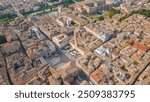 An aerial view of Parma, Italy, showcasing the iconic Cattedrale di Parma and the Battistero di Parma, captured by a drone.  This historic city is known for its rich cultural heritage