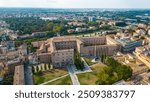 An aerial view of Parma, Italy, showcasing the iconic Cattedrale di Parma and the Battistero di Parma, captured by a drone.  This historic city is known for its rich cultural heritage