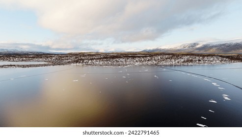 Aerial View of a Partially Frozen Lake in Norway's Winter - Powered by Shutterstock