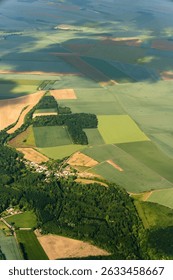 Aerial View of Patchwork Farmland Fields. For illustrating rural agriculture, land use, and countryside planning in educational or commercial contexts.