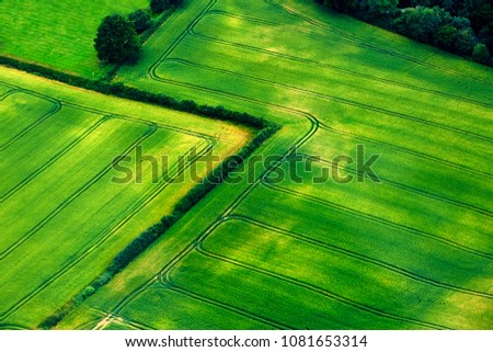 Similar – Aerial view of lush green rice field with small winding canal. Sustainable agriculture landscape. Sustainable rice farming. Rice cultivation. Green landscape. Organic farming. Sustainable land use.