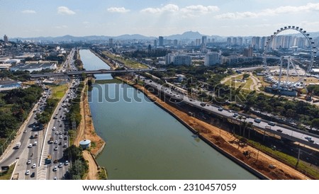 Aerial view of São Paulo traffic on the Margina Pinheiros highway captured from above on a sunny day in 2023 by a drone in the sky.