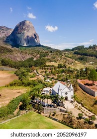 Aerial view of Pedra Azul, with vegetation, houses, village and church. In the mountain region of Domingos Martins in Espírito Santo, Brazil.