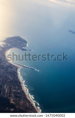 Aerial View of Peniche and baleal. Popular surf spots in Portugal near Lisbon and Atlantic Ocean. View from the porthole of an airplane.