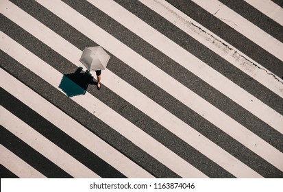 Aerial View Of People Crossing A Big Intersection In Tokyo, Japan . Street Photo, Umbrella Have One Leg