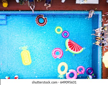 Aerial view of people enjoying the pool with inflatable tubes